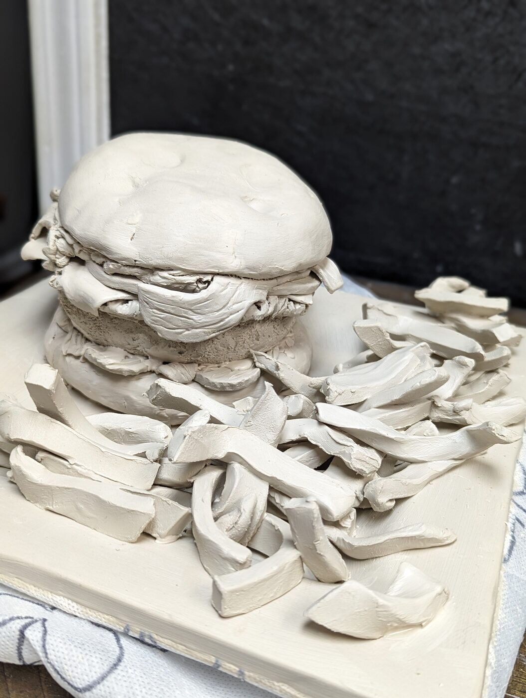 Handbuilt clay pieces drying before firing