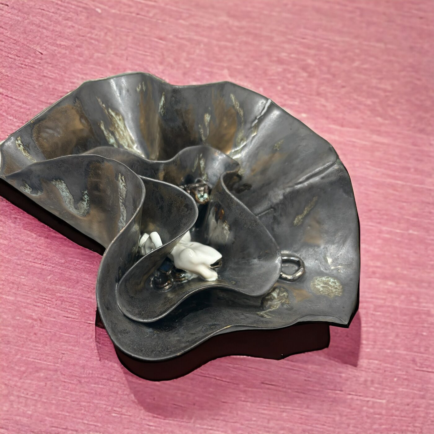 Sculptural ceramic dish with metallic wave-like form