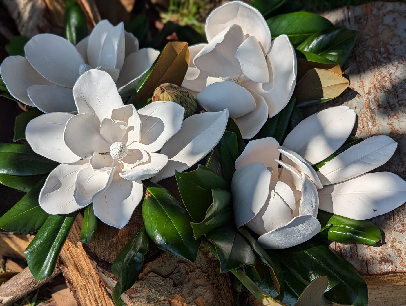 Handbuilt ceramic magnolias styled outdoors