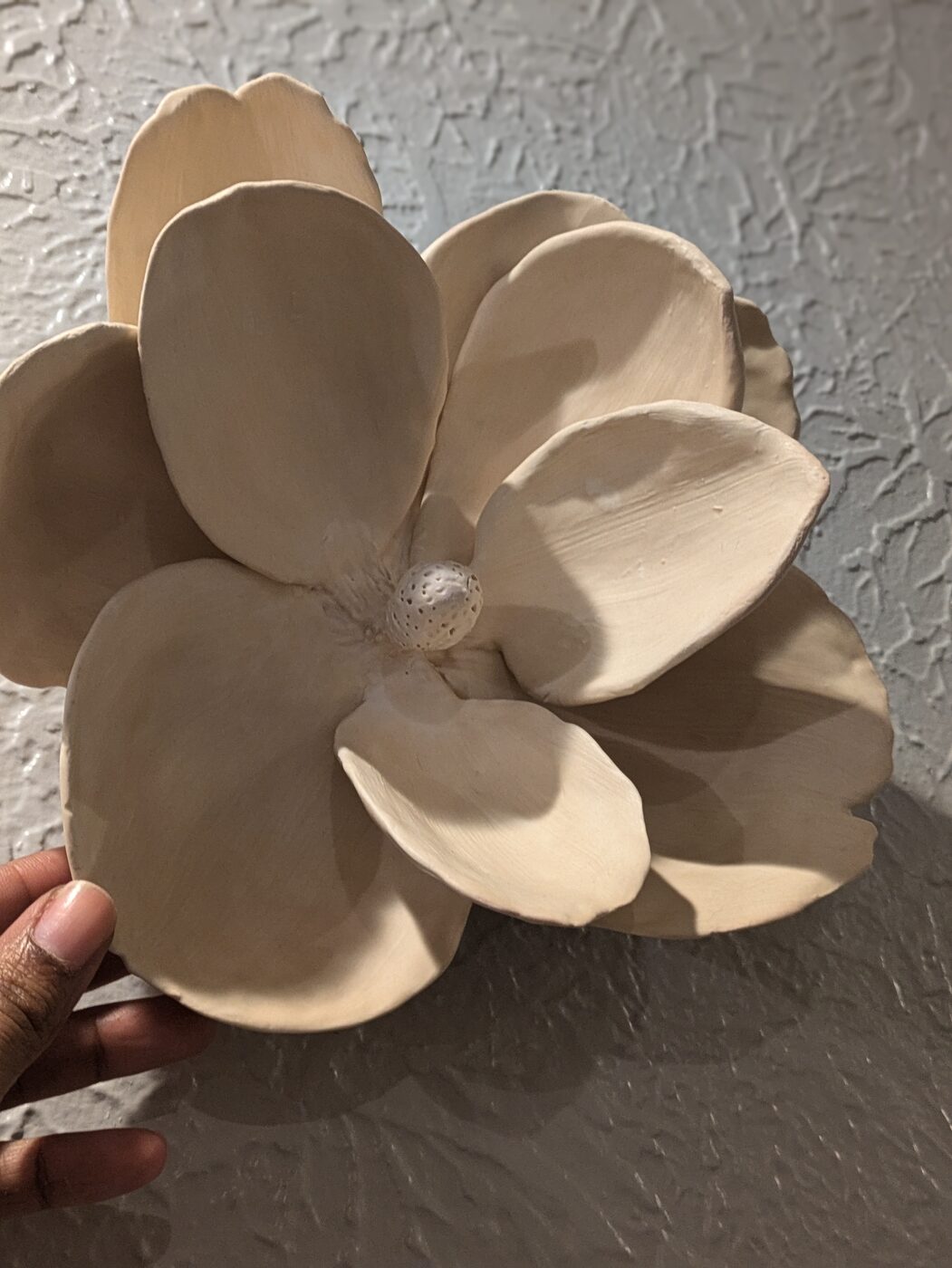 Handbuilt ceramic magnolia in hand