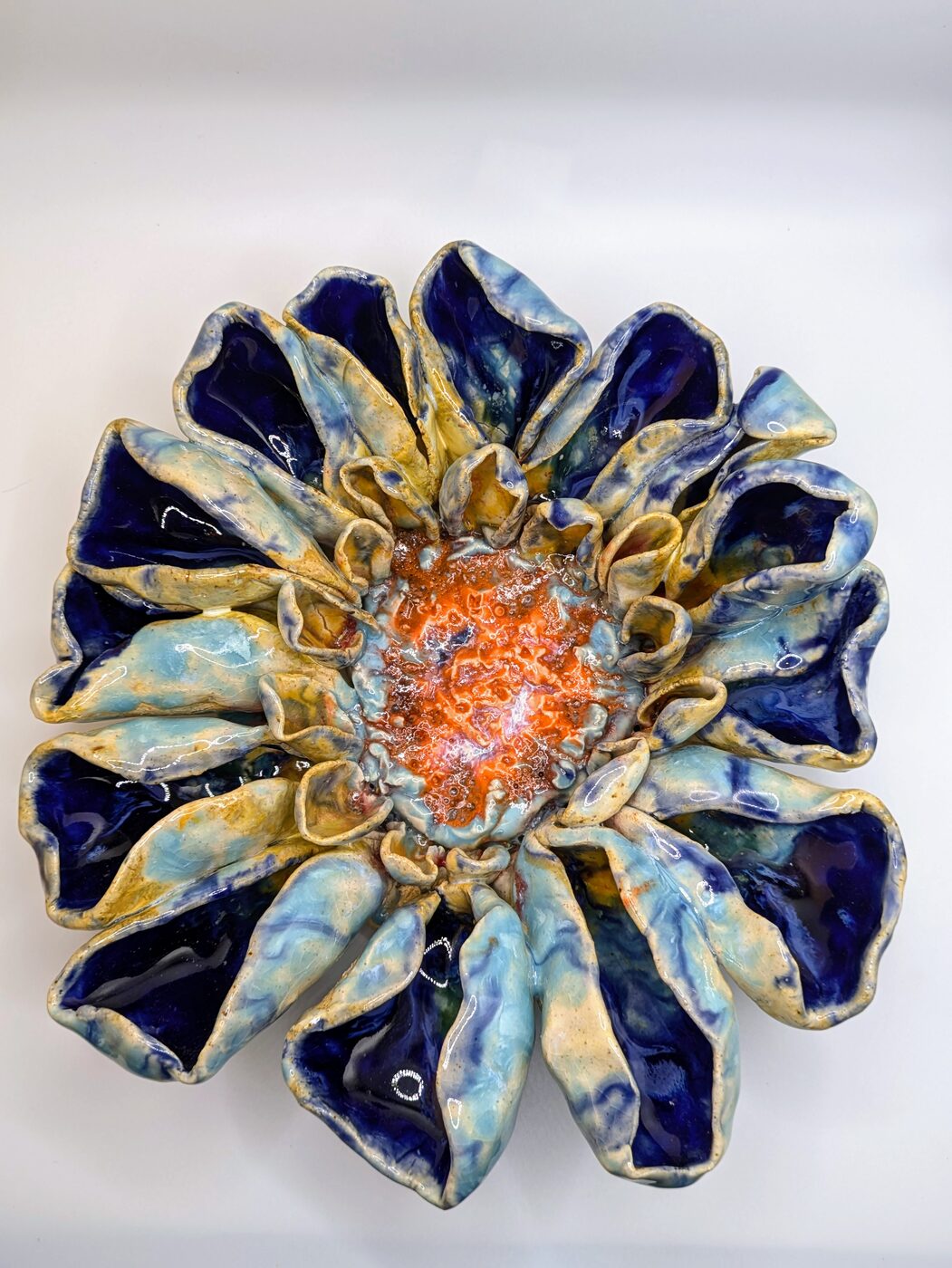 Handbuilt ceramic blue and gold flower closeup
