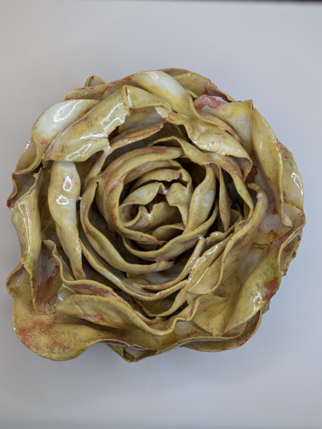 Handbuilt ceramic sage-toned rose closeup
