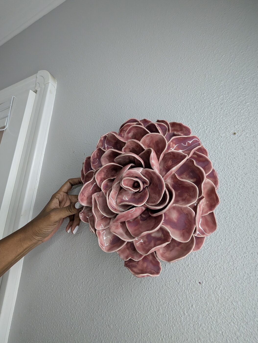 Handbuilt ceramic pink rose on wall