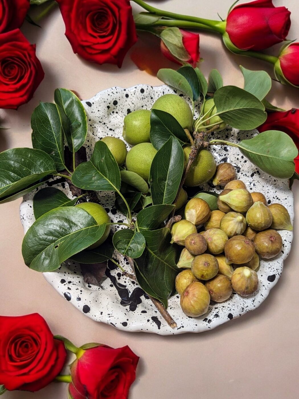 Splatter-glaze ceramic plate styled with roses and figs