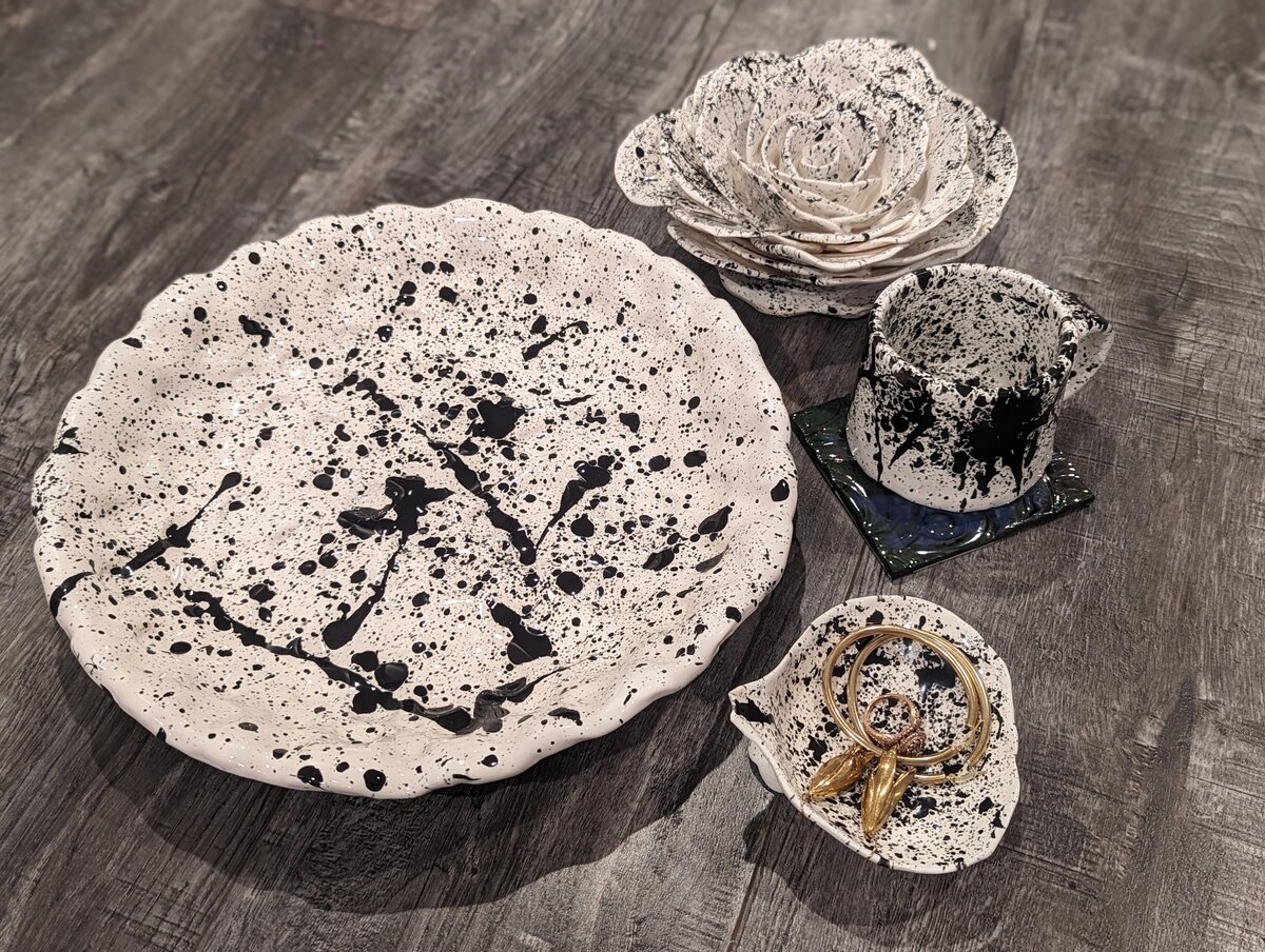 Splatter-glazed ceramic plate and bowls